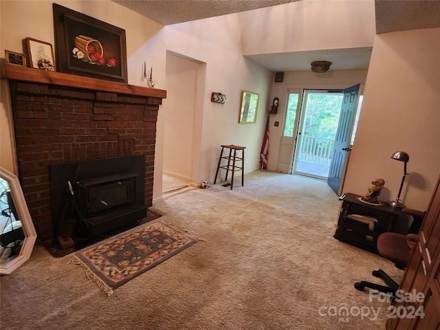 foyer featuring carpet and a textured ceiling