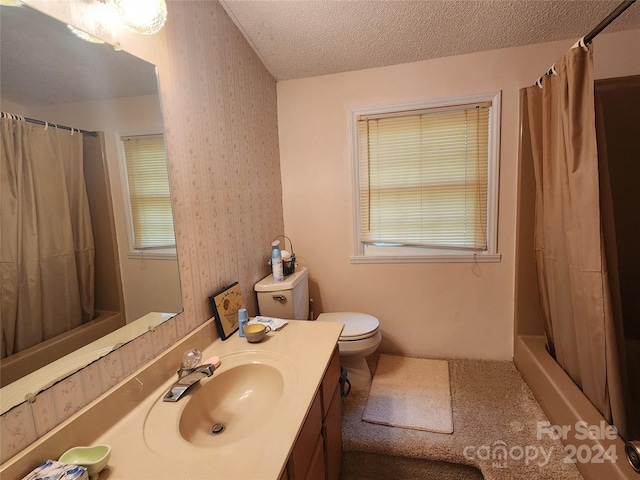 bathroom with toilet, a textured ceiling, shower / tub combo, wallpapered walls, and vanity