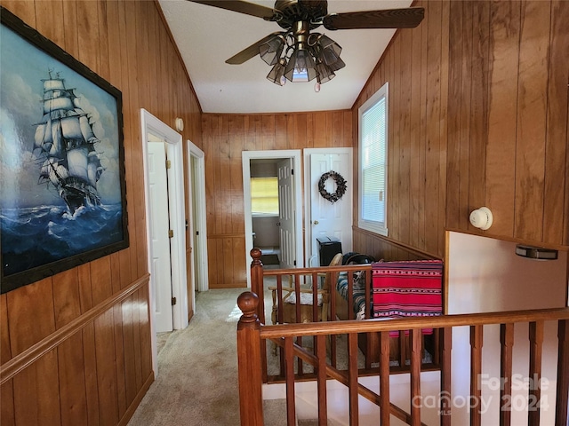 hall with wood walls and carpet floors