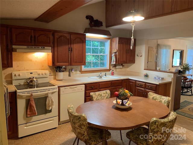 kitchen with under cabinet range hood, a sink, white appliances, light countertops, and light floors