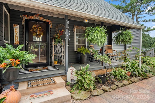 view of exterior entry featuring a porch