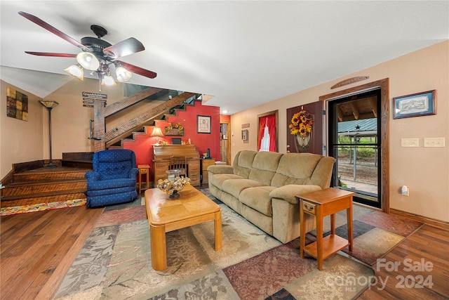 living room featuring wood-type flooring and ceiling fan