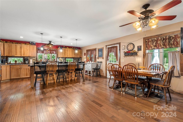 dining area with dark hardwood / wood-style flooring and ceiling fan