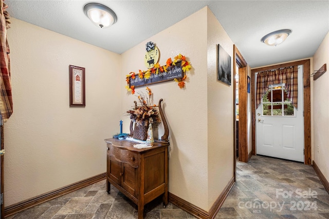 hallway featuring a textured ceiling