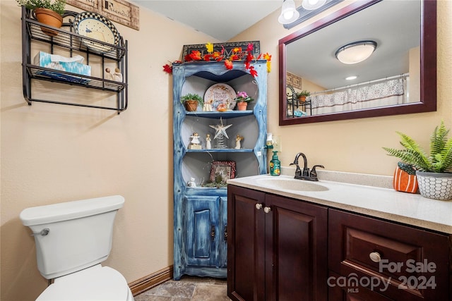 bathroom featuring vanity, toilet, and a shower with shower curtain