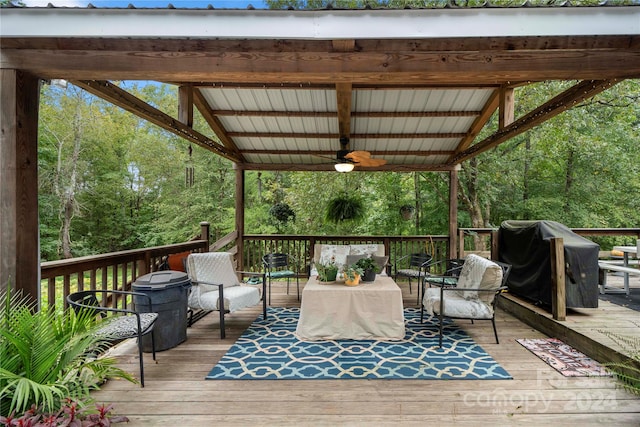 deck featuring an outdoor living space, ceiling fan, and a grill