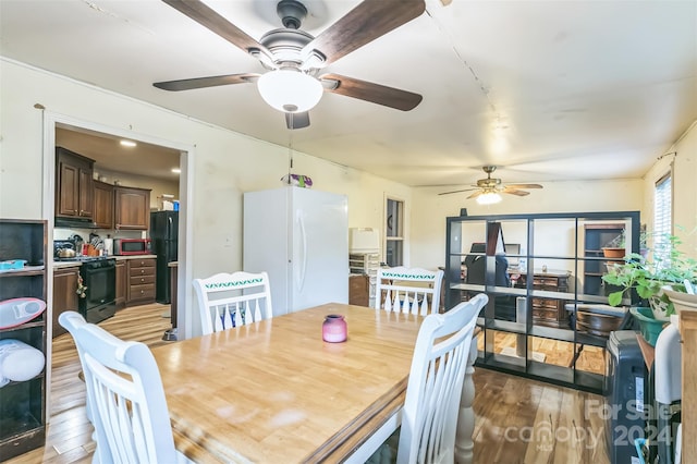 dining room with ceiling fan and light hardwood / wood-style floors