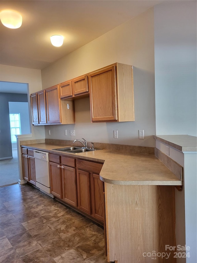 kitchen with kitchen peninsula, sink, and white dishwasher