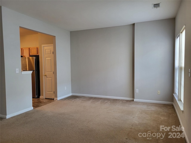 carpeted spare room with a healthy amount of sunlight