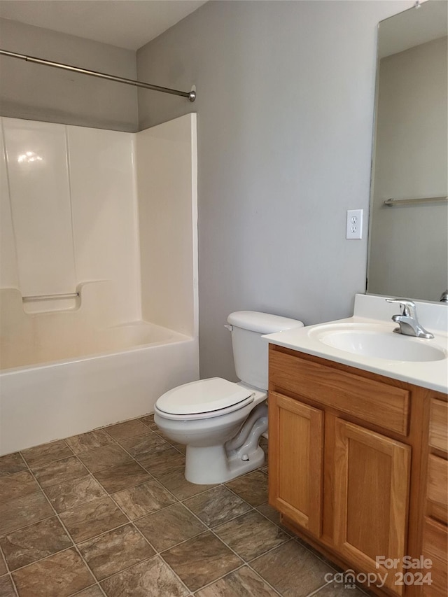 full bathroom featuring vanity, toilet, and washtub / shower combination