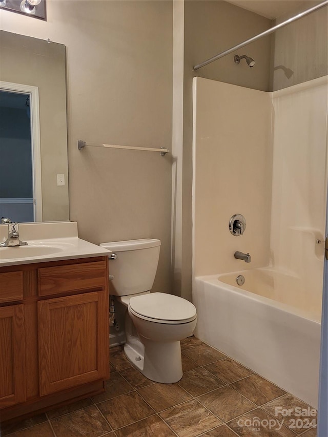 full bathroom featuring vanity, toilet, and washtub / shower combination