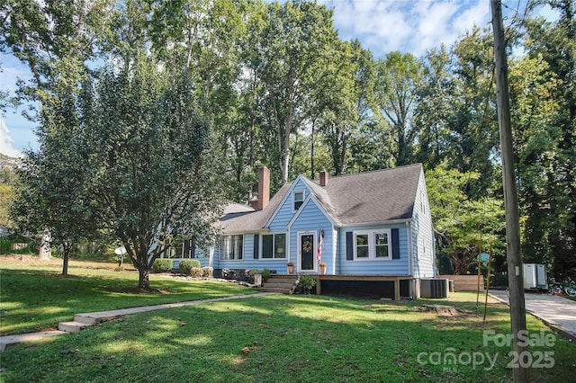 view of front facade with central AC and a front lawn