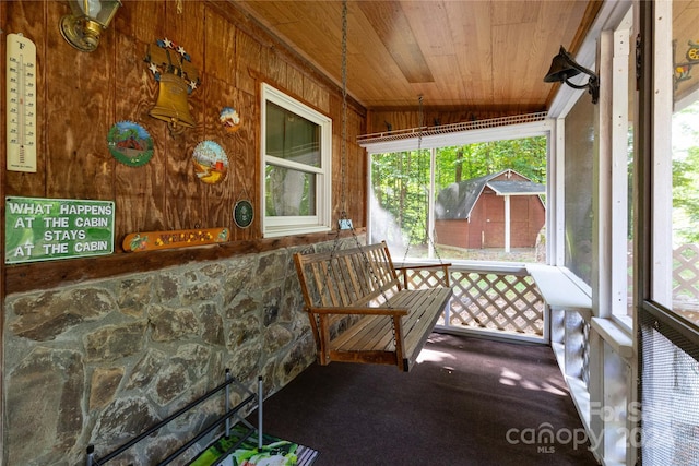 sunroom / solarium with lofted ceiling and wood ceiling