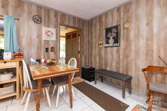 tiled dining room featuring wooden walls