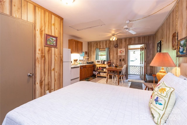 bedroom featuring white fridge, light tile patterned floors, wooden walls, and ceiling fan