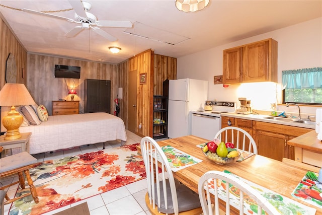 tiled bedroom with ceiling fan, white fridge, sink, and wooden walls