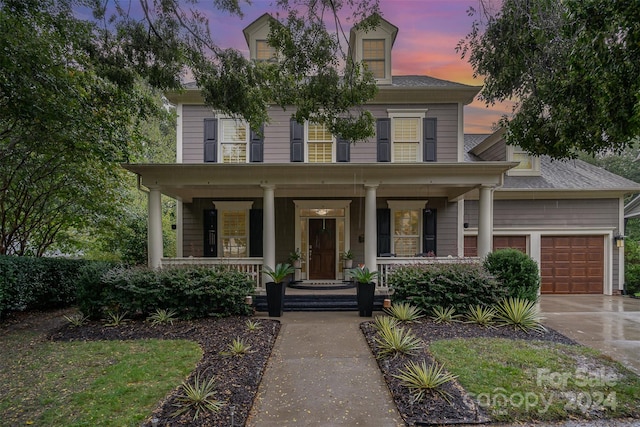 view of front of home with a porch and a garage