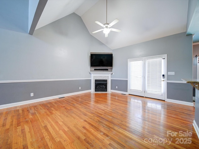 unfurnished living room featuring ceiling fan, high vaulted ceiling, and light hardwood / wood-style floors