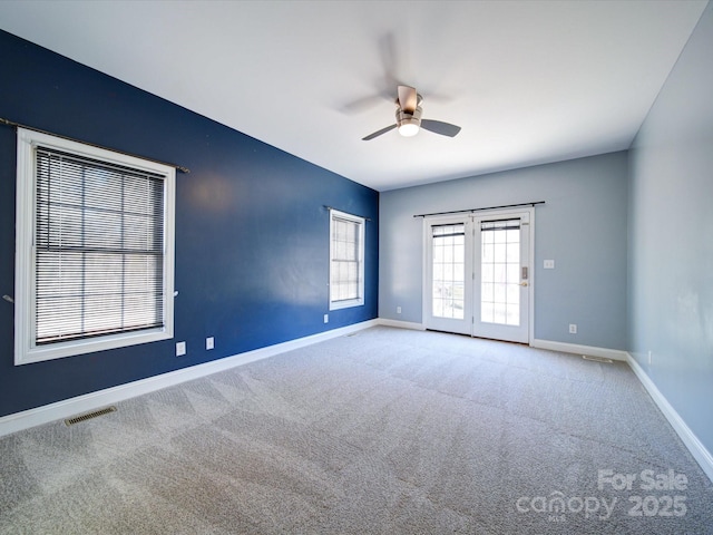 empty room featuring light carpet and ceiling fan