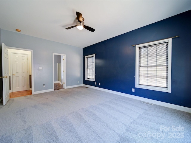 unfurnished bedroom featuring ceiling fan and carpet