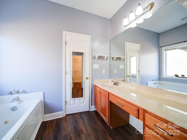 bathroom with vanity, hardwood / wood-style floors, and a bathing tub