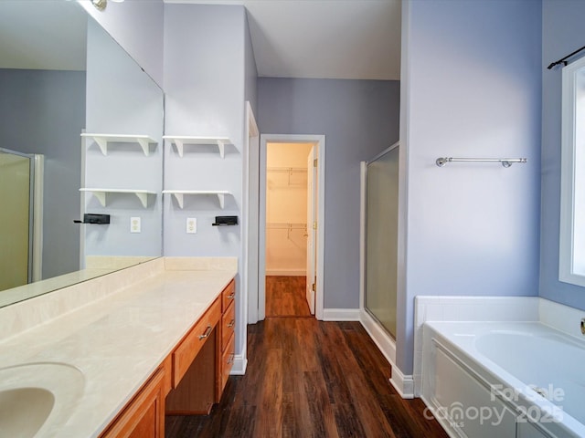 bathroom featuring independent shower and bath, vanity, and hardwood / wood-style flooring