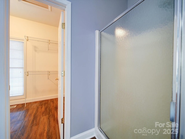 bathroom featuring hardwood / wood-style floors and a shower with door