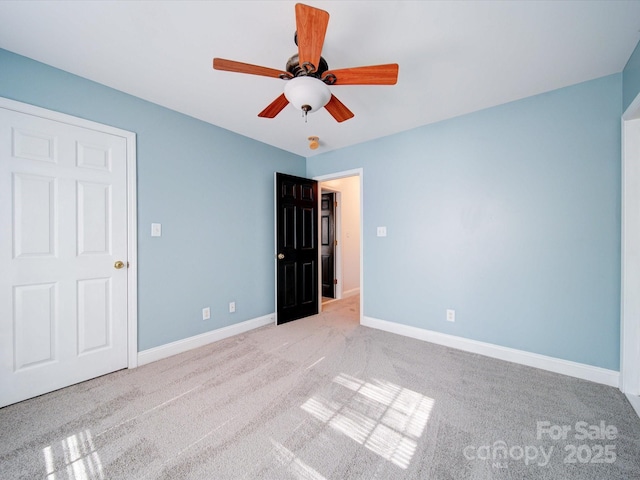 unfurnished bedroom featuring light colored carpet and ceiling fan