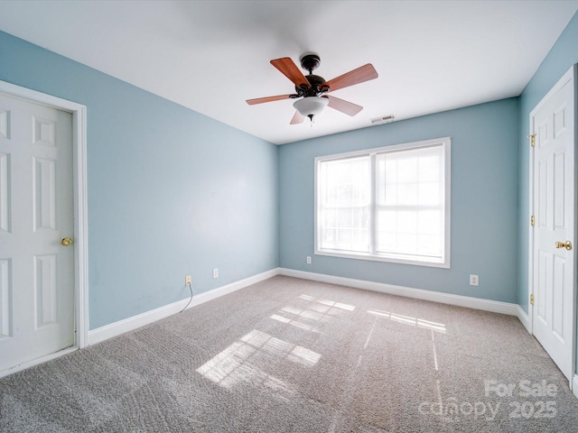 carpeted empty room with ceiling fan