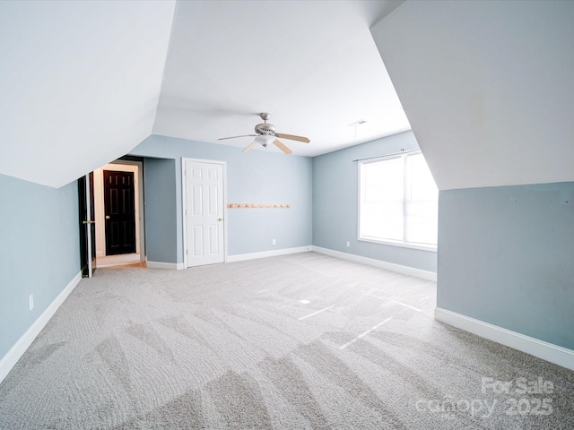 bonus room featuring ceiling fan, light colored carpet, and vaulted ceiling