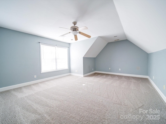 bonus room with light carpet, vaulted ceiling, and ceiling fan