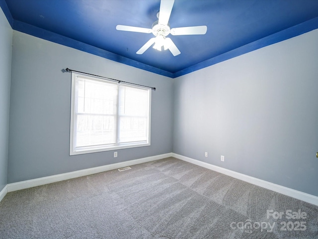 carpeted spare room with ceiling fan