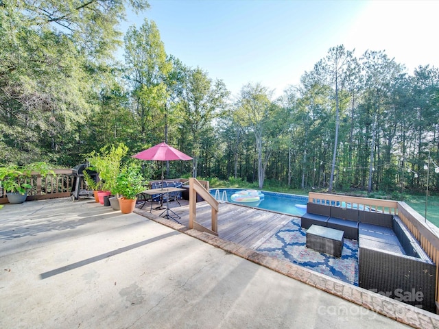 view of swimming pool with an outdoor living space and a deck