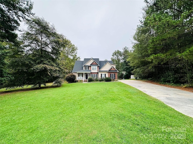 view of front of home featuring a front yard and a porch