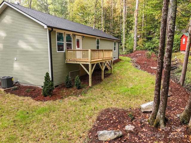 view of yard featuring central AC unit and a deck