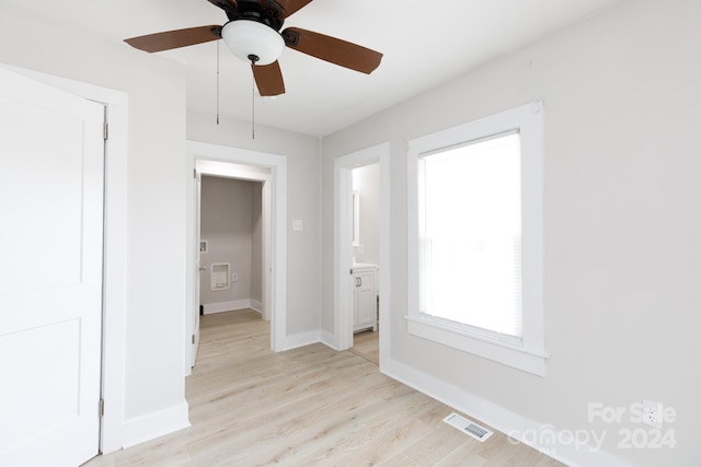 spare room featuring light hardwood / wood-style flooring and ceiling fan