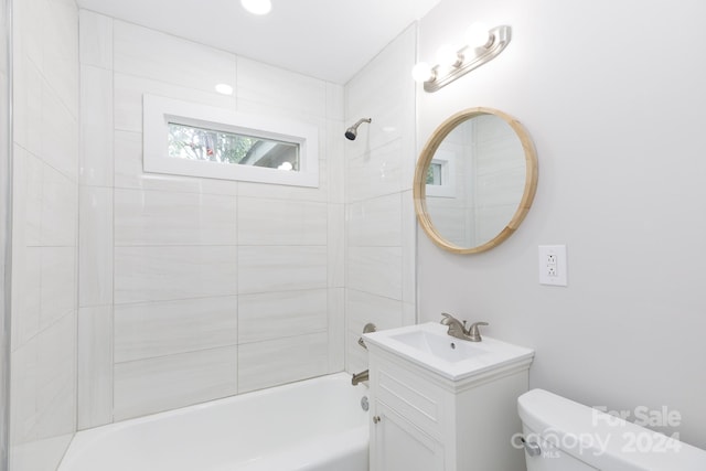 full bathroom with vanity, toilet, and tiled shower / bath combo