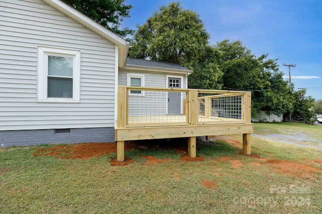 wooden deck with a lawn