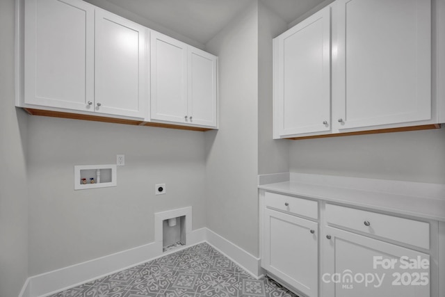 laundry area with electric dryer hookup, cabinets, light tile patterned floors, and washer hookup