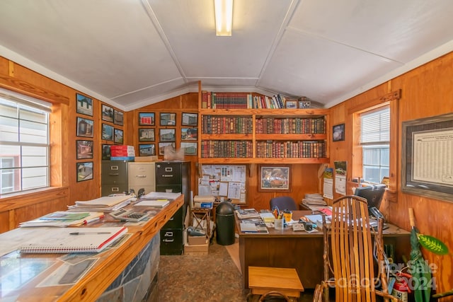 office area featuring lofted ceiling, carpet flooring, and wooden walls