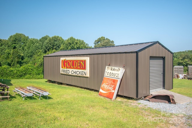 view of outdoor structure with a yard and a garage