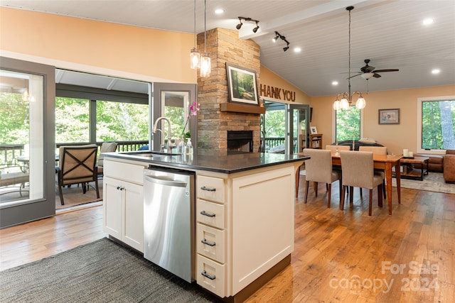 kitchen featuring dark hardwood / wood-style floors, sink, pendant lighting, vaulted ceiling with beams, and dishwasher