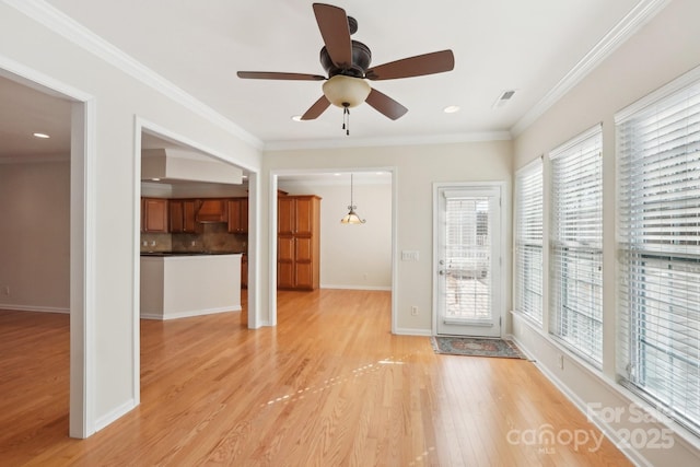 unfurnished living room with ceiling fan, light wood-type flooring, and crown molding