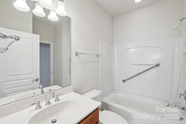 full bathroom featuring toilet, vanity, and shower / bathtub combination