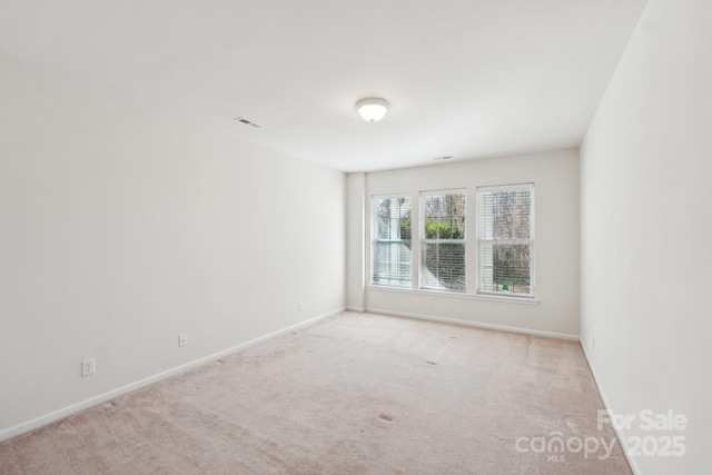 empty room featuring light colored carpet