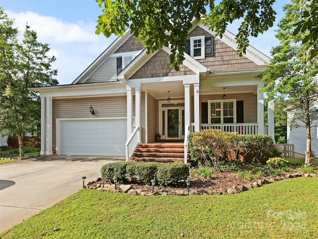 craftsman-style home with ceiling fan, a garage, a front yard, and covered porch