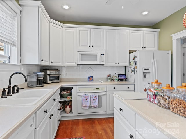 kitchen featuring white cabinets, white appliances, light hardwood / wood-style floors, and sink