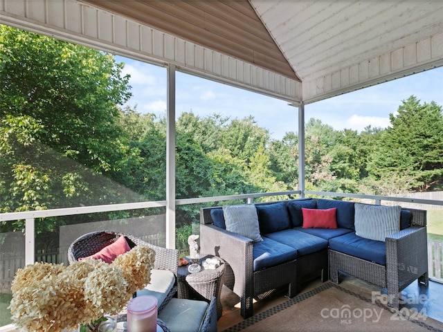 sunroom / solarium featuring vaulted ceiling