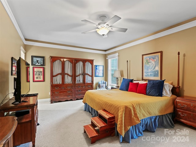 carpeted bedroom with ornamental molding and ceiling fan