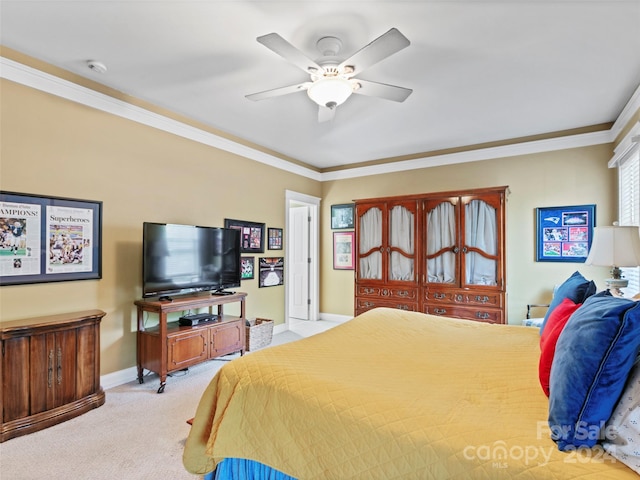 carpeted bedroom with ceiling fan and ornamental molding